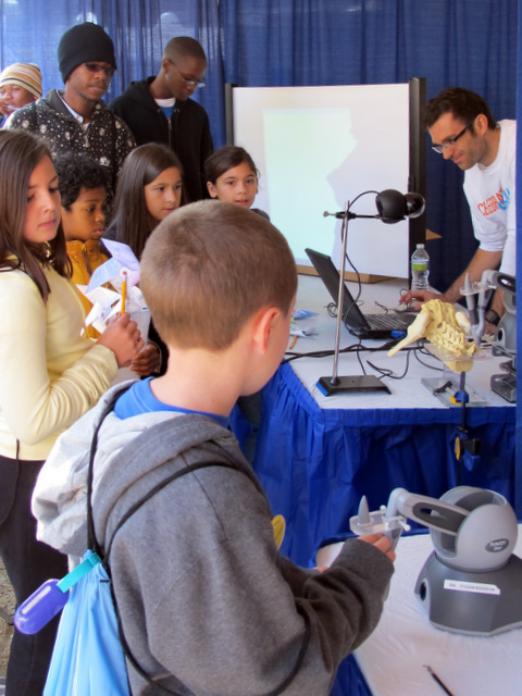 Marcin demonstrating teleoperation to a future scientist.